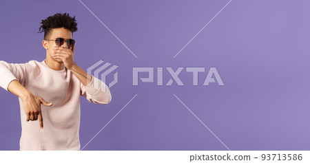 Waist-up portrait of cool young handsome guy with dreads, sunglasses on, hold hand over mouth while beatboxing, waving hand to shake audience up, reading own rap, purple background Waist-up portrait of cool young handsome guy with dreads, sunglasses on, hold hand over mouth while beatboxing, waving hand to shake audience up, reading own rap, purple background 93713586