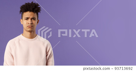 Close-up portrait of skeptical and gloomy, disappointed hispanic young man frowning upset, feel uneasy about bad idea, grimacing with disapproval, standing unhappy purple background Close-up portrait of skeptical and gloomy, disappointed hispanic young man frowning upset, feel uneasy about bad idea, grimacing with disapproval, standing unhappy purple background 93713692