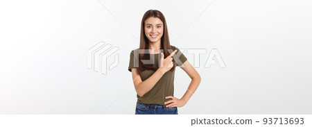 Portrait happy and surprised young lady standing isolated over grey background. Looking camera pointing. 93713693