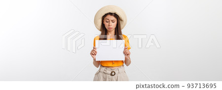 Young caucasian woman holding blank paper sheet over isolated background scared in shock with a surprise face, afraid and excited. Young caucasian woman holding blank paper sheet over isolated background scared in shock with a surprise face, afraid and excited. 93713695