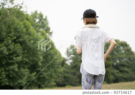 Rear view of a woman running in the park 93714817