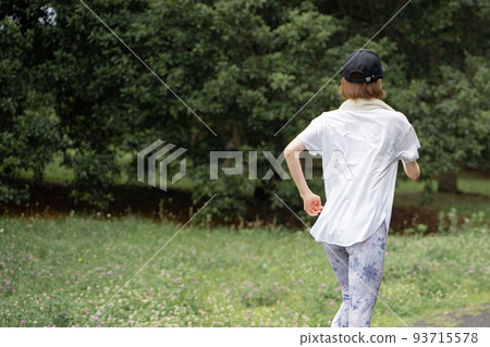 A woman jogging in the park 93715578