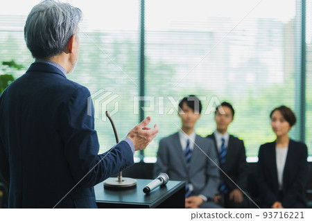 A man with gray hair giving a speech 93716221