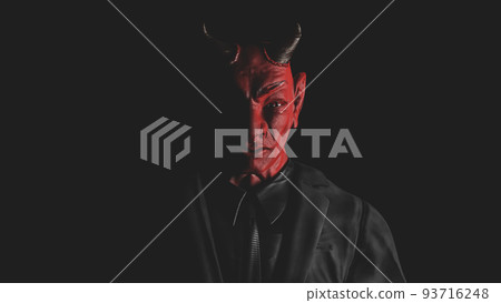Appearance of red devil from the darkness. light from the side. Appearance of red devil from the darkness. light from the side. 93716248