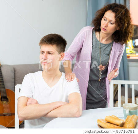 Worried mother scolding teenage son Worried mother scolding teenage son 93716791