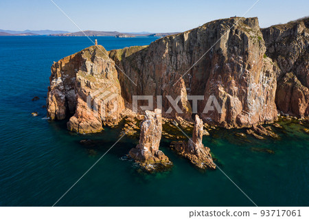 Two sea stacks in the sea. Abandoned lighthouse on top of a rocky island Two sea stacks in the sea. Abandoned lighthouse on top of a rocky island 93717061