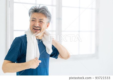 Senior man wiping his sweat with a towel Active senior 93721533