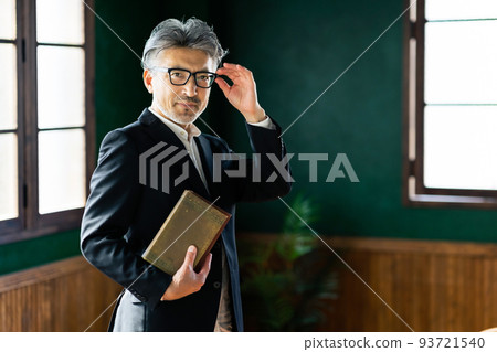 Middle-aged man holding a book Professor Author 93721540
