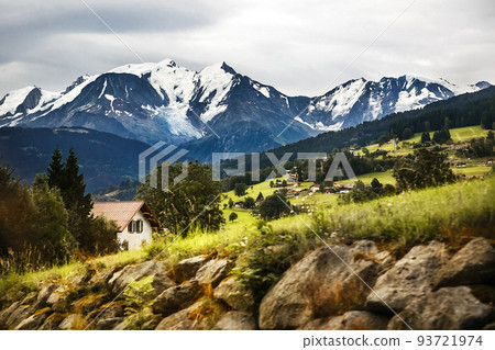 The village is in the mountains. Snow-capped mountains and forest The village is in the mountains. Snow-capped mountains and forest 93721974