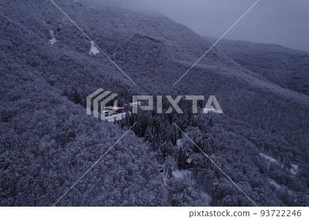 Aerial view of the mountains range with clouds and storm clouds in twilight. Caucasus Mountains, Plateau Lago-Naki. Aerial view of the mountains range with clouds and storm clouds in twilight. Caucasus Mountains, Plateau Lago-Naki. 93722246
