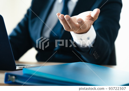 Hand of a businessman explaining to a personal computer 93722307