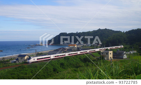 A white express train running along the Pacific coast 93722785