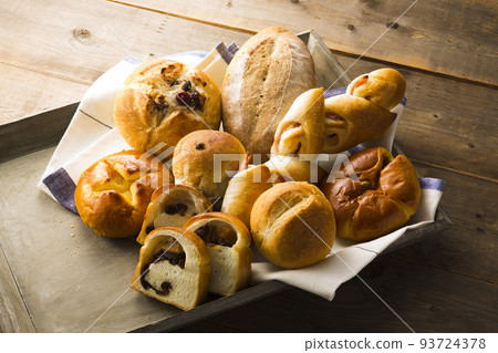 Assorted bread on a tray and cut bread 93724378