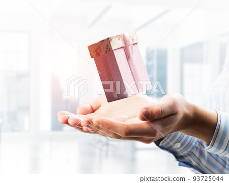 Concept of xmas or celebration with present box in male palms. Mixed media Concept of xmas or celebration with present box in male palms. Mixed media 93725044