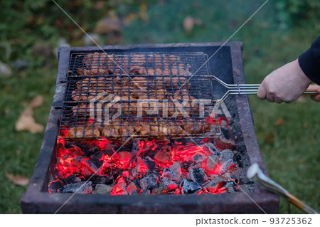 Juicy and fresh pieces of pork are roasted on the charcoal grill. Fragrant smoke and red-hot charcoal. Juicy and fresh pieces of pork are roasted on the charcoal grill. Fragrant smoke and red-hot charcoal. 93725362