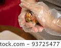 Female hands making dough for mooncake, homemade cantonese moon cake pastry on baking tray before baking for traditional festival. Travel, holiday, food concept 93725477