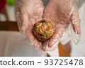 Female hands making dough for mooncake, homemade cantonese moon cake pastry on baking tray before baking for traditional festival. Travel, holiday, food concept 93725478