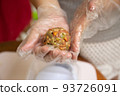 Female hands making dough for mooncake, homemade cantonese moon cake pastry on baking tray before baking for traditional festival. Travel, holiday, food concept 93726091