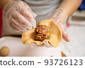 Female hands making dough for mooncake, homemade cantonese moon cake pastry on baking tray before baking for traditional festival. Travel, holiday, food concept 93726123