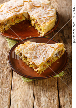 Fresh baked traditional Moroccan Pastilla or chicken bastilla closeup in the plate. Vertical Fresh baked traditional Moroccan Pastilla or chicken bastilla closeup in the plate. Vertical 93726639