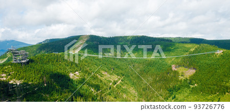 Aerial view of suspension Sky Bridge 721 and observation tower in mountains, Dolni Morava, Czech Republic. Aerial view of suspension Sky Bridge 721 and observation tower in mountains, Dolni Morava, Czech Republic. 93726776