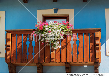 Wooden Balcony with White and Red Geranium Flowers - Friuli Italy 93726802