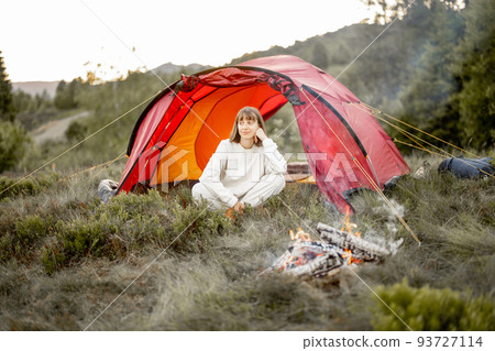 Young woman enjoys nature while travel in the mountains 93727114