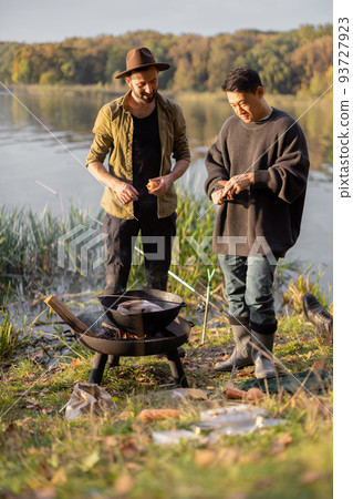 Multiracial friends having a picnic on fishing Multiracial friends having a picnic on fishing 93727923