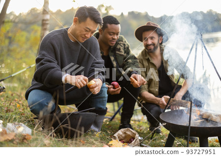 Multiracial friends having a picnic on fishing Multiracial friends having a picnic on fishing 93727951
