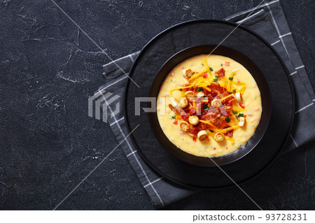 savory creamy pumpkin soup in bowl, top view 93728231