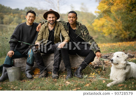 Multiracial male friends rest and talk in nature Multiracial male friends rest and talk in nature 93728579