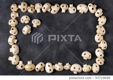 Frame of raw champignon mushrooms in the form of skulls. Edible Halloween Concept Frame of raw champignon mushrooms in the form of skulls. Edible Halloween Concept 93729086