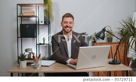 Businessman freelancer enters office workplace, working on laptop computer, sends online messages 93729711