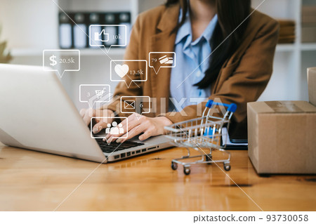 Woman start up small business owner writing address on cardboard box at workplace.small business entrepreneur SME or freelance asian woman working with box at home. 93730058