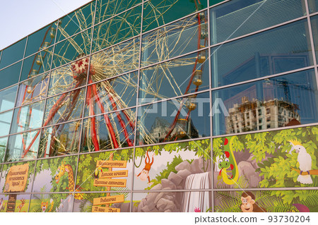 Round ferris wheel spins fast at colorful day 93730204