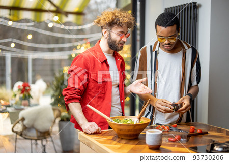 Two guys cooking healthy together at home 93730206