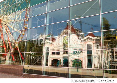 Round ferris wheel spins fast at colorful day 93730207