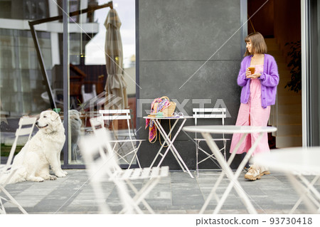 Woman with dog at cafe outdoors 93730418