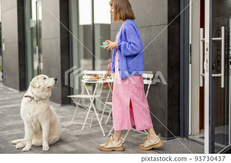 Woman with dog at cafe outdoors 93730437