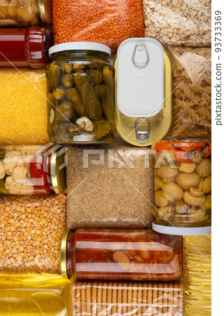 Emergency survival groceries on kitchen table closeup flat lay Emergency survival groceries on kitchen table closeup flat lay 93733369