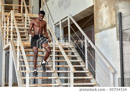 Sport Motivation. Black Male Athlete Running Up On Urban Stairs Outdoors, Enjoying Morning Workout, With Free Space Sport Motivation. Black Male Athlete Running Up On Urban Stairs Outdoors, Enjoying Morning Workout, With Free Space 93734334