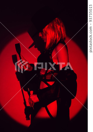 sexy girl with a leather whip in underwear and hat. BDSM concept of a dominant woman 93735015