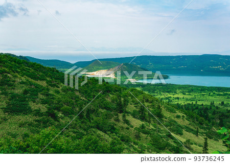 landscape of Kunashir Island, geothermal lakes among lava domes in the center of Golovnin volcano caldera; the island of Hokkaido is visible in the distance in the sea landscape of Kunashir Island, geothermal lakes among lava domes in the center of Golovnin volcano caldera; the island of Hokkaido is visible in the distance in the sea 93736245
