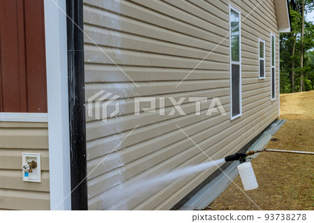 A cleaning service with a powerful nozzle that sprays water on a high-pressure soap cleaner, including cleaning and maintaining houses 93738278