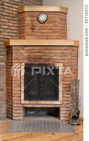 Old brick fireplace with black doors Old brick fireplace with black doors 93738415
