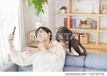 Parents and children competing for smartphones in the living room Parents and children competing for smartphones in the living room 93738736