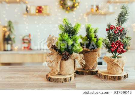 Christmas decor on the kitchen table, made of wood and Christmas tree branches 93739043