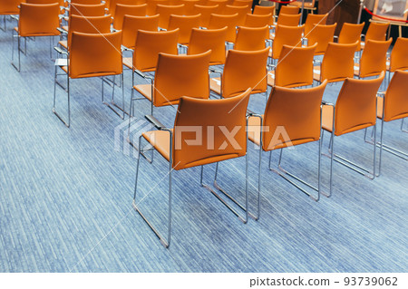 large empty conference room with orange chairs before the auction large empty conference room with orange chairs before the auction 93739062
