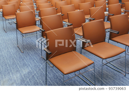 large empty conference room with orange chairs before the auction 93739063