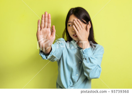 Korean Woman Gesturing Stop And Covering Face Over Yellow Background 93739368